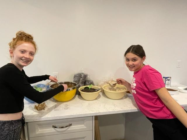 photo of Grade 8 students, Tori and Claire with mixing bowls