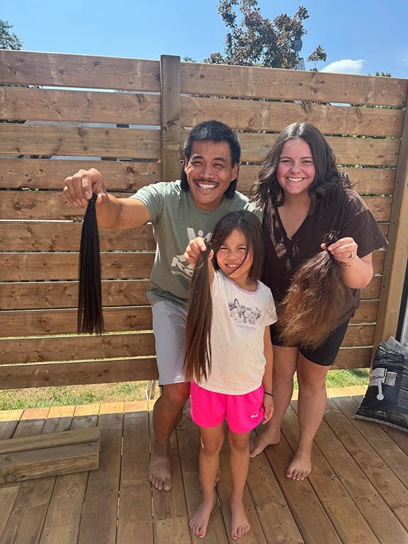 Sofia, her dad and her aunt holding their hair